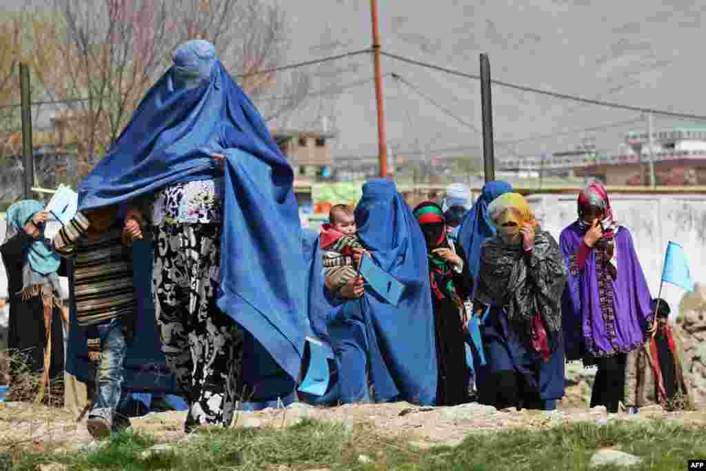 Supporters of Afghan presidential candidate Abdullah Abdullah arrive for an election gathering in Charikar. Afghanistan&#39;s April 5 election is the third presidential poll since the fall of the Taliban with 11 candidates contesting the polls.
