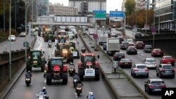 Farmer drive their tractors on the Paris ring road in Paris, France, Nov. 27, 2019.