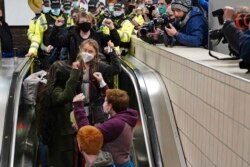 Climate activist Greta Thunberg, center, arrives at Central Railway station in Glasgow, Scotland, Oct. 30, 2021, ahead of the start of COP26.
