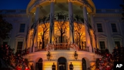 FILE - President Donald Trump and first lady Melania Trump depart after giving candy to children during a Halloween trick-or-treat event on the South Lawn of the White House.