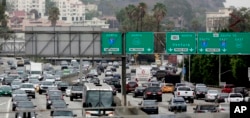 FILE - Vehicles are backed up while entering the US 101 Ventura Freeway as traffic from US 101 enters into downtown Los Angeles, Aug. 25, 2015.
