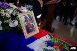 The photo of Marckendy Natoux, a journalist killed by armed gangs on Dec. 24, 2024, is on display during his funeral service in Port-au-Prince on Jan. 18, 2025.