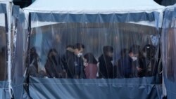 People queue in line to wait for the coronavirus testing at a makeshift testing site in Seoul, South Korea on Dec. 22, 2021.