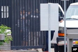 FILE - Authorities move immigrant children into a van from a youth holding facility to an undisclosed location, July 10, 2018, in Phoenix.