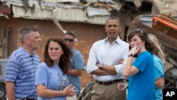 President Barack Obama views the devastation at Plaza Towers Elementary School caused by tornado and severe weather last week with school officials, May 26, 2013, in Moore, Oklahoma.