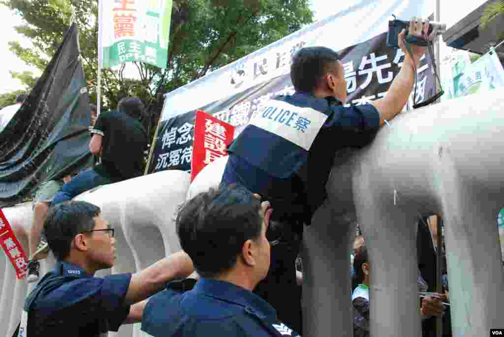 Police are also up on the blocks to take shots of the protest scene.