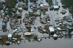 Floodwater slowly recedes in the aftermath of Hurricane Ida in Lafitte, La., Sept. 1, 2021.
