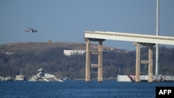 The remains of the collapsed Francis Scott Key Bridge lie in the Patapsco River on March 29, 2024, three days after a container ship struck it, in Baltimore, Maryland. Rebuilding the bridge could take several years and cost up to nearly $1 billion.