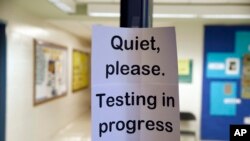 FILE - A sign is seen at the entrance to a hall for a college test preparation class in Bethesda, Md., Jan. 17, 2016.