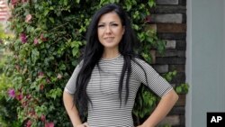 Lorin Lynch poses for a photo outside her home, June 8, 2020, in Wesley Chapel, Fla. When the tourists stopped coming in March, so did Lynch's paychecks from a Tampa Bay hotel.