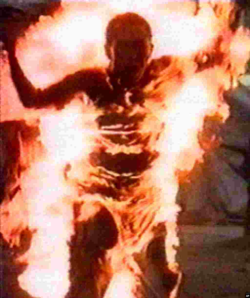 A Tibetan activist burns after setting himself on fire to protest police action to halt a hunger strike April 27. Police threw water on Thupten Ngodup to douse the flames and rushed him to hospital where one doctor said his chance of survival was 'negligi