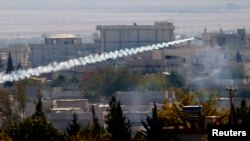 FILE - A rocket believed to have been launched by Islamic State forces flies from the east to the west side of the Syrian town of Kobani during fighting, Nov. 6, 2014 Picture taken from the Turkish side of the Turkey-Syria border. 