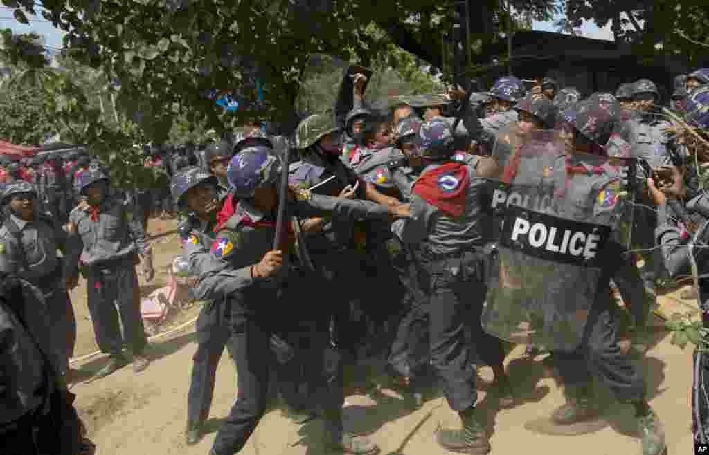 Police officers beat a student protester during a crackdown in Letpadan, Myanmar, March 10, 2015.