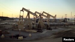 FILE - Oil pumpjacks owned by Occidental Petroleum Corp. operate near Long Beach, California, July 30, 2013.