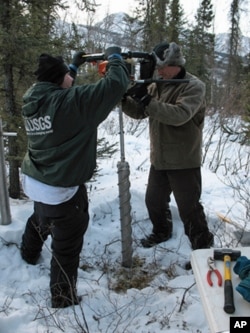 Core samples for microbial analysis are retrieved from the Alaskan permafrost.