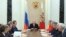 Russian President Vladimir Putin (C) chairs a meeting with members of the Security Council at the Kremlin in Moscow, Mar. 6, 2015. Russia is seen as using propaganda and money to, as one analyst put it, "divide and split Europe." 