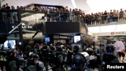 Riot police try to disperse protesters inside a mall in Sha Tin District in Hong Kong, July 14, 2019.