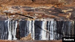 FILE - Uranium ore is heap leached with sulfuric acid at Areva's Somair mine in Arlit on September 25, 2013. 