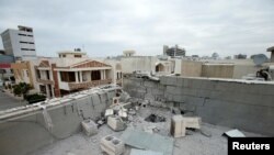 FILE - A damaged roof is seen after a barrage of rockets hit in and near Irbil International Airport, in Irbil, Feb. 16, 2021. The Kurdish interior ministry said a drone attack April 14, 2021, at the airport damaged a building, but caused no injuries.