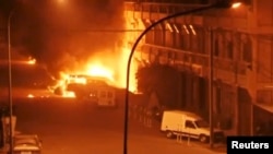 A view shows vehicles on fire outside Splendid Hotel in Ouagadougou, Burkina Faso in this still image taken from a video, Jan. 15, 2016, during a siege by Islamist gunmen. 