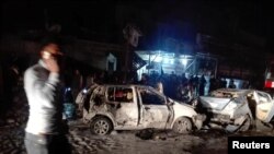 Destroyed cars are seen at the site of a car bomb attack in the Amil neighborhood in Baghdad, Iraq, March 20, 2017. 