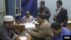 Para petugas di Kairo, Mesir melakukan perhitungan atas referendum hari Minggu (20/3).