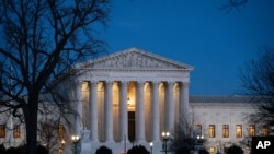 FILE - Night falls on the Supreme Court in Washington.