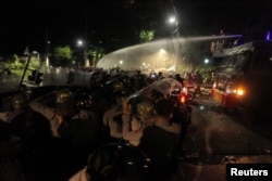 Police use a water cannon to disperse a crowd gathered outside the Indonesian Legal Aid Foundation during an anti-communist protest in Jakarta, Indonesia, early Sept. 18, 2017. Antara Foto/Muhammad Adimaja/ via Reuters