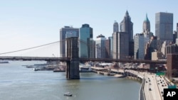 The Brooklyn Bridge and lower Manhattan skyline are shown in a view from the Manhattan Bridge, New York