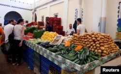 People buy vegetables on the first day of the Muslim holy fasting month of Ramadan at a market in Tunis, Tunisia, May 27, 2017.