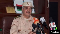 FILE - Eastern Libyan military commander Khalifa Haftar speaks during a news conference in Al Marj, east of Benghazi, Libya, June 4, 2014. 