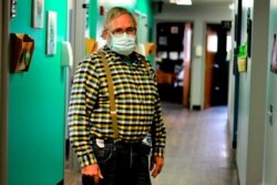 Dr. Tom Dean is pictured at his clinic in Wessington Springs, S.D., Oct. 16, 2020. Dean is one of three doctors in the county, which has seen one of the nation's highest rates of coronavirus cases per person.