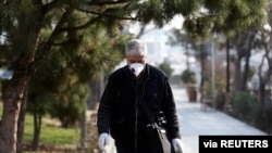 An Iranian man wears a protective mask against the coronavirus as he walks on a street in Tehran, Iran February 29, 2020.