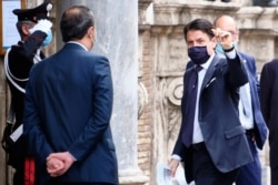 Prime minister Giuseppe Conte wears a face mask to prevent the spread of COVID-19 as he arrives to address parliament on the next European Council meeting, in Rome, June 17, 2020.