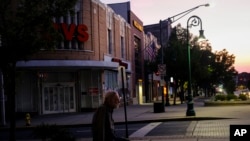 A man smokes a cigarette in front of the "Latino Americans for Trump" office in Reading, Pa., on June 16, 2024.