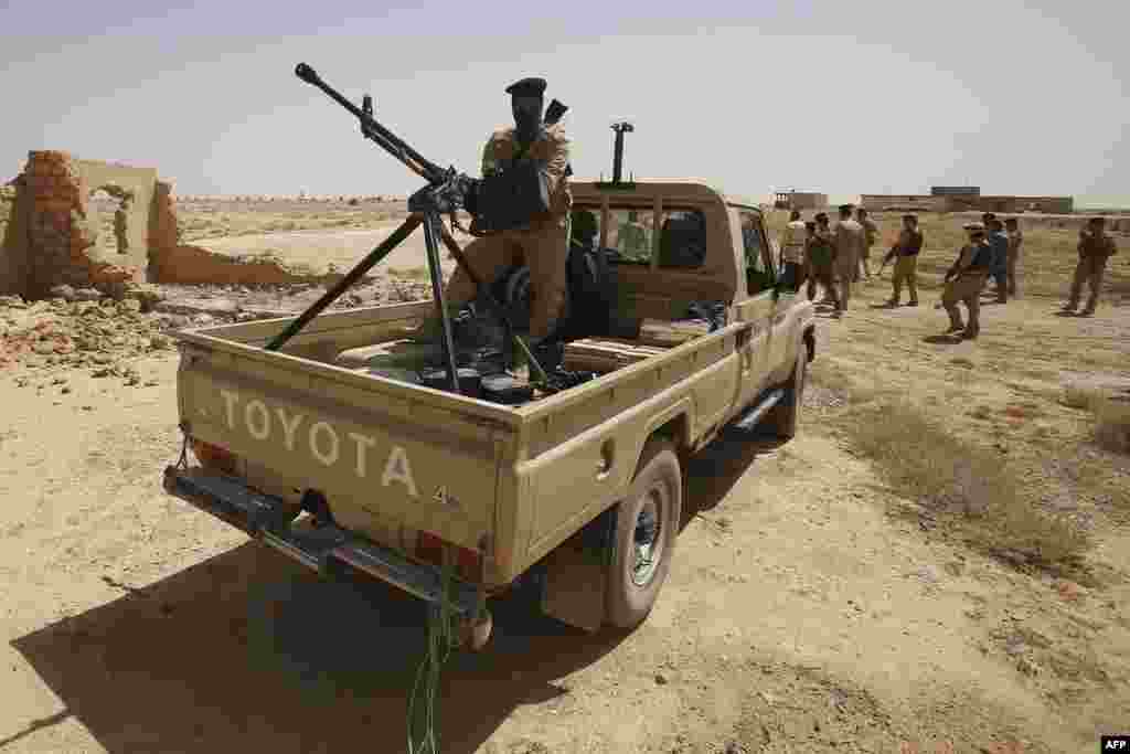 Iraqi troops monitor an area west of the shrine city of Karbala, in central Iraq, June 29, 2014. 