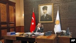 Turkey's Prime Minister Tayyip Erdogan in his office at the AK Party headquarters the day after his they scored a resounding third consecutive election victory, in Ankara, Turkey, June 13, 2011