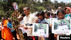 People march to the killing site of Cambodian anti-logging activist Chut Wutty in Koh Kong province, May 11, 2012.