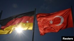 FILE - Turkish and German flags flutter before the visit of Turkish President Recep Tayyip Erdogan, at the airport in Berlin, Germany, Sept. 27, 2018.
