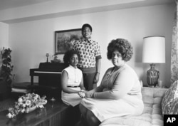 Linda Brown, right, and her two children pose for a photo in their home in Topeka, Kansas.