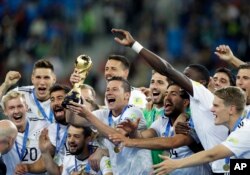 FILE - In this July 2, 2017, photo, Germany's Julian Draxler holds the trophy after winning the Confederations Cup final soccer match between Chile and Germany, at the St. Petersburg Stadium, Russia.