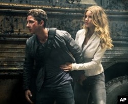 Left to right: Shia LaBeouf plays Sam Witwicky and Rosie Huntington- Whiteley plays Carly in TRANSFORMERS: DARK OF THE MOON, from Paramount Pictures.