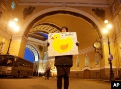 A protester holds a poster reading "Stop to lie and to steal please" during an unauthorized rally in St. Petersburg, Russia, March 6, 2017. About 30 activists gathered to discuss a report accusing Prime Minister Dmitry Medvedev of corruption, which was prepared by opposition leader Alexei Navalny.