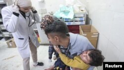 A Palestinian holds a child wounded in an Israeli strike at Nasser Hospital, amid the ongoing conflict between Israel and the Palestinian Islamist group Hamas, in Khan Younis in the southern Gaza Strip Jan. 22, 2024.