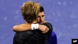 Novak Đoković i Aleksandar Zverev na mreži posle polufinala US Opena, u Njujorku, 10. septembra 2021. (Foto: AP/Seth Wenig)