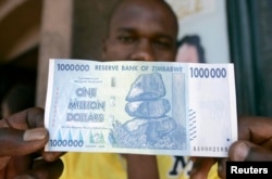 FILE - A black market foreign currency dealer displays the new $1 million banknote worth $7 on the streets of Harare, October 6, 2008.