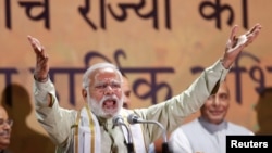 India's Prime Minister Narendra Modi addresses his supporters in New Delhi, India, March 12, 2017. In his home state Hindu-Muslim violence left one dead. 