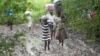 Villagers carry food for people taking care of their livestock in Tsholostho, about 200 kilometers north of Bulawayo, Zimbabwe, March 4, 2017.