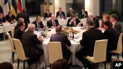 Kanselir Jerman Angela Merkel (kedua dari kanan) menjadi tuan rumah pembicaraan dengan Presiden Rusia Vladimir Putin (nomor 5 sebelah kiri), Presiden Perancis Francois Hollande (kiri), dan Presiden Ukraina Petro Poroshenko (nomor 5 sebelah kanan, membelakangi kamera) di kantor Kanselir (19/10). Berlin, Jerman (foto: Michael Kappeler/Pool Photo via AP)