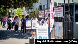 People stand in line to get a COVID-19 vaccine outside Kheir Center, nonprofit health care and human service agency in the Koreatown neighborhood of Los Angeles.CA.